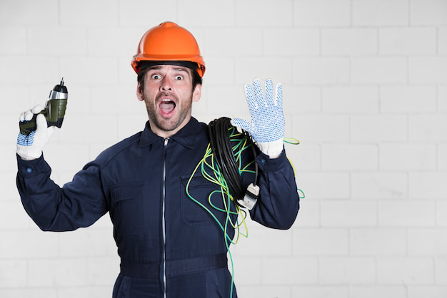 A surprised construction worker wearing a hard hat