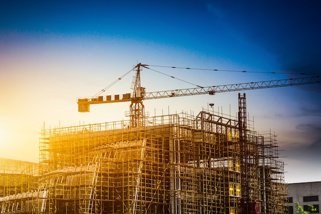 Silhouette of a construction site at sunset.